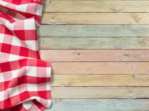 Fototapeta red checkered picnic tablecloth on colorful wood table