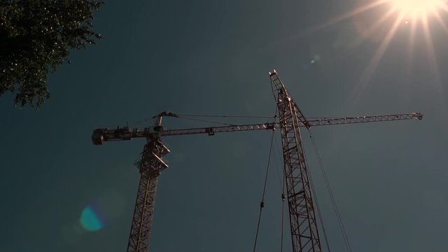 Construction Industry. Tower Crane Working Against Blue Sky