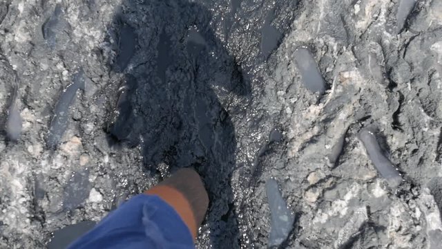 Female Walking Barefooted Across Wet and Dirty Mud Pond. HD Slowmotion POV.