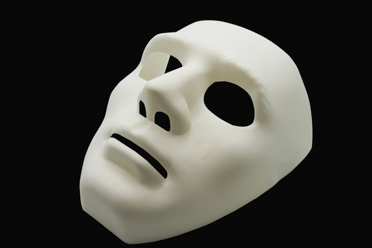 White human mask isolated on black background.