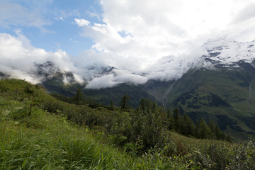 Fototapeta na wymiar Clouds and snow in summertime in Austria