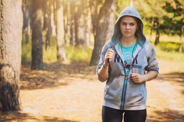 nice young girl on morning jog in a summer forest