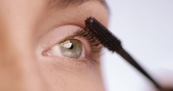 Mascara is applied to a beautiful green eye