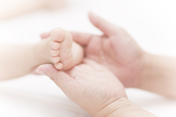 baby feet in mother hand