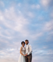 Young beautiful couple  over natural background ooking at the camera