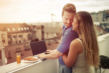 Couple hugging outdoors in top of building