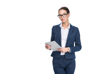 attractive serious businesswoman using digital tablet, isolated on white