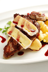 Roasted meat on the plate with brie cheese