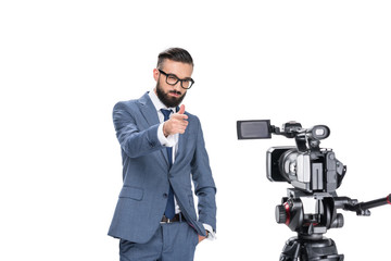 television reporter gesturing and standing in front of tv camera, isolated on white