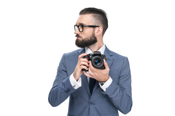 handsome male photographer holding professional camera, isolated on white