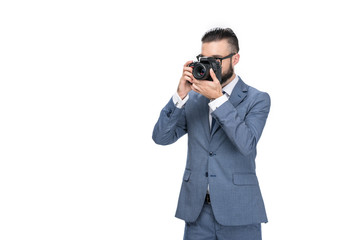 male photographer taking photo on professional camera, isolated on white