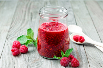 Homemade jam with raspberry on the wooden table