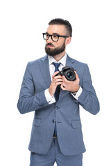 handsome male photographer taking photo on professional camera, isolated on white