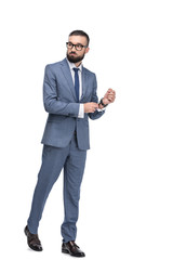 Obraz premium confident handsome businessman posing in grey suit, isolated on white