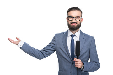 handsome smiling male journalist with microphone presenting something, isolated on white