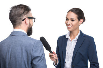 happy female journalist interviewing businessman in suit, isolated on white