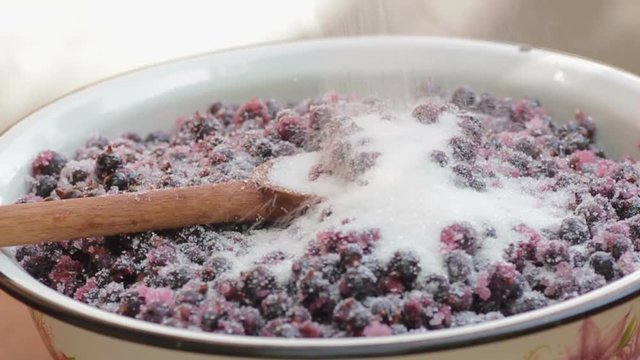 The cook prepares jam from the black currant