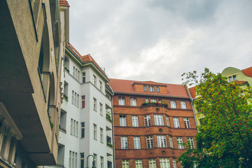 brown and white houses on a cloudy background