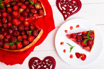 Strawberry pie on white plate and white wooden table. One piece. Top view.  Romantic. Love. Heart.