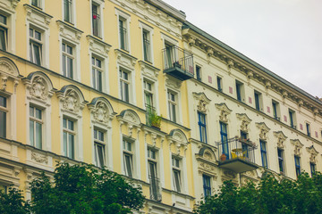 Naklejka premium yellow and classical facades of row houses exterior
