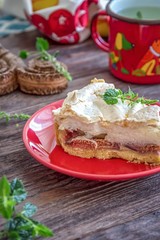 Homemade pie with figs and meringue on a wooden background