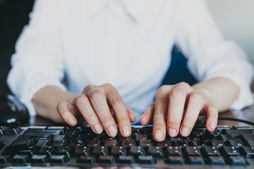 Woman's hands typing on keyboard - obrazy, fototapety, plakaty