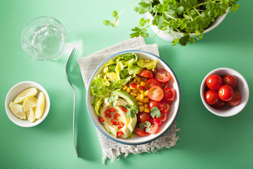 healthy vegan avocado salad with tomatoes and sweetcorn
