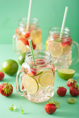 refreshing summer lemonade with strawberry and lime in mason jar