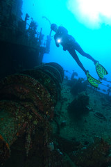 Fototapeta na wymiar Lonely scuba diver inside the Giannis D wreck with hand light