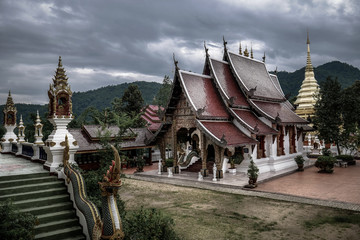 Buddhist temple in dark atmosphere with cloudy sky, nobody inside, chiang mai, thailand