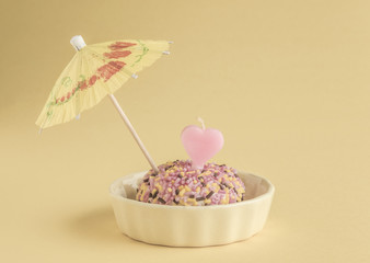 Small birthday cake with heart shaped candle