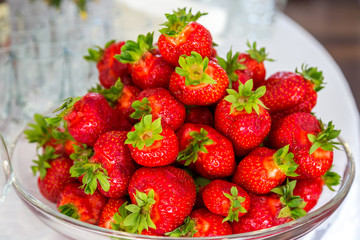 Sweet wild strawberries in plate