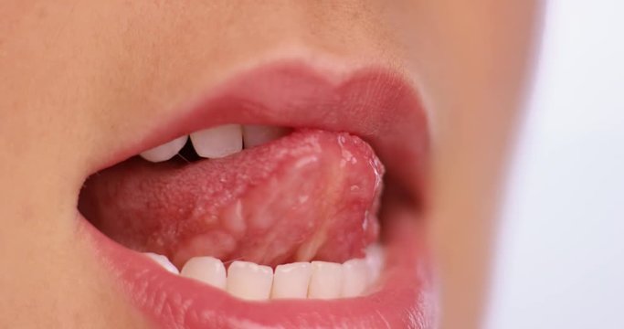 Macro shoot of a mouth covered with lip gloss
