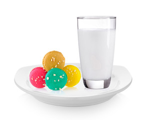milk and macaroons in white plate on white background