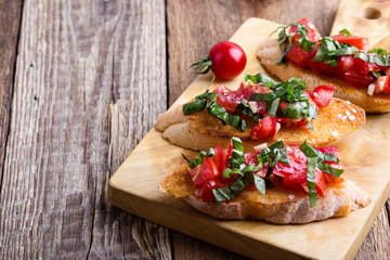 Fototapeta na wymiar Tomato and basil bruschetta with toasted garlic bread
