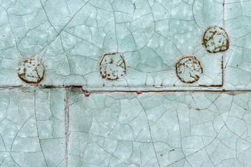 Old blue painted riveted metal door detail