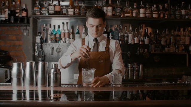 The bartender makes a cocktail
