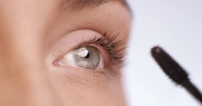 One green eye is made with mascara - close-up