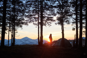 Silhouette of a person standing on top of a mountain enjoying beautiful natural landscape while out camping copyspace people lifestyle active vitality travelling hiking