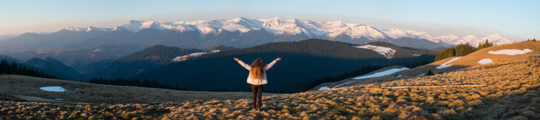 Panoramic. Full length rearview shot of an adventurous female hiker standing on top of the mountain with her arms spread lifestyle vitality happiness achievement hiking travelling nature