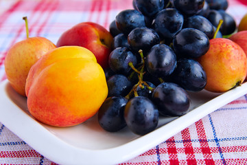 Bunch of black grapes and peaches