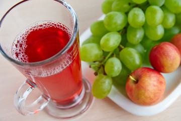 A glass of grape juice and fresh fruit