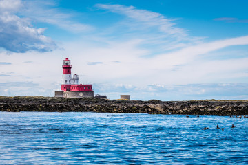 Fototapeta na wymiar Farne Islands Longstone Rock and Lighthouse / Longstone Rock Lighthouse was made famous as the base for Grace Darling's rescue of survivors from a shipwreck