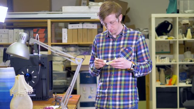 An engineer checks over a 3d-printed jaw bone. 