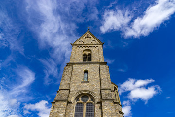 Fototapeta premium Roman church tower in Schoeneberg Village Hunsrueck, Rhineland-Palatinate, Germany.