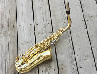Saxophone on a wooden background.Golden saxophone. Soprano Saxophone.Wind musical instrument
