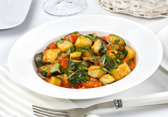 Vegetarian dish of zucchini and tomato.