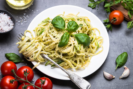 Pasta spaghetti with zucchini basil and cheese.