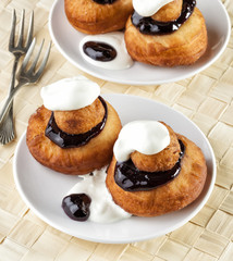 Sweet dessert of beignets with chocolate and cream