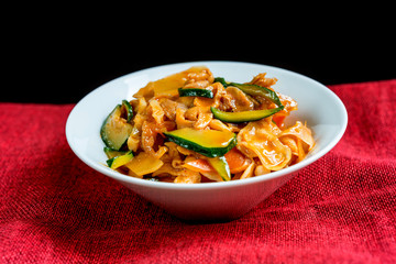 wok fried chicken stir fry with sweet peppers and chinese vegetables